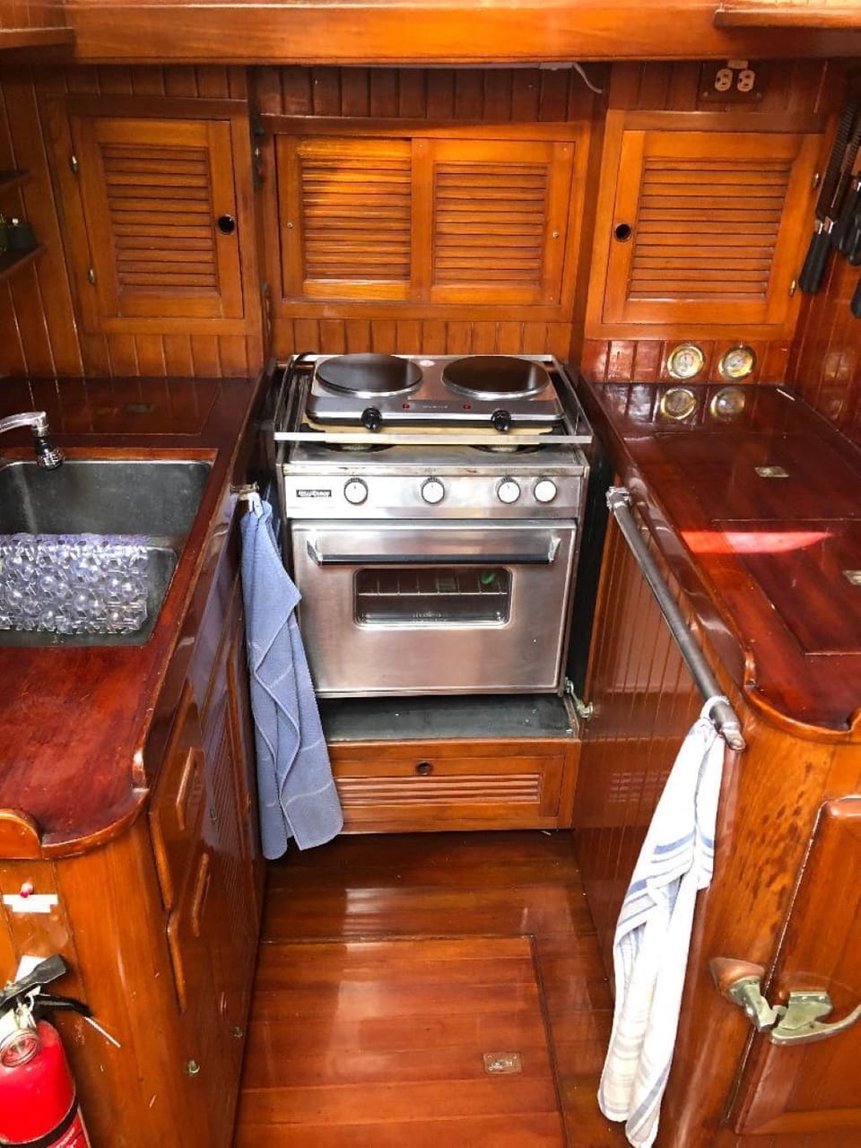 Galley (kitchen) with double sink, 2 burner electric stovetop and fridge/freezer
