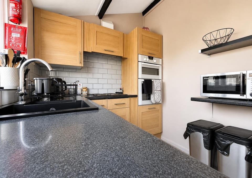 The bright modern kitchen is perfect for grabbing your morning coffee before heading to the spa for a morning soak in the hot tub.