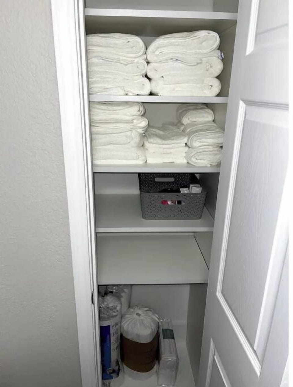 Fully stocked linen closet.