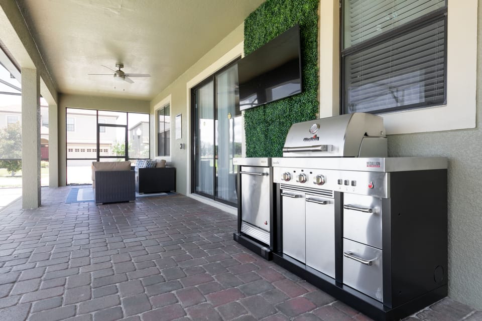 Covered patio with summer kitchen and smart TV