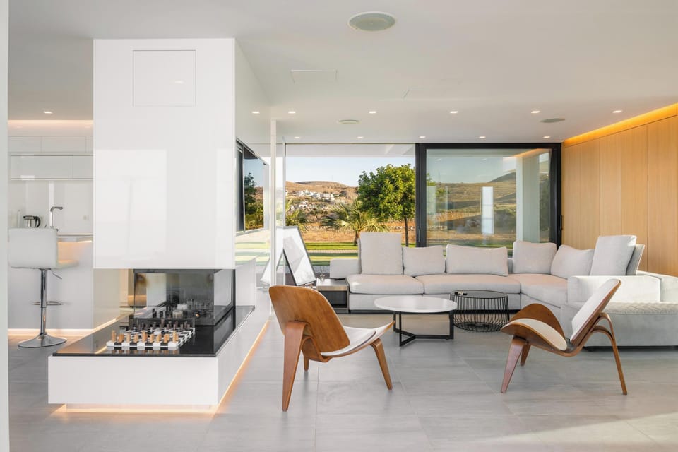 Open plan living room area with floor-to-ceiling windows connecting to the veranda