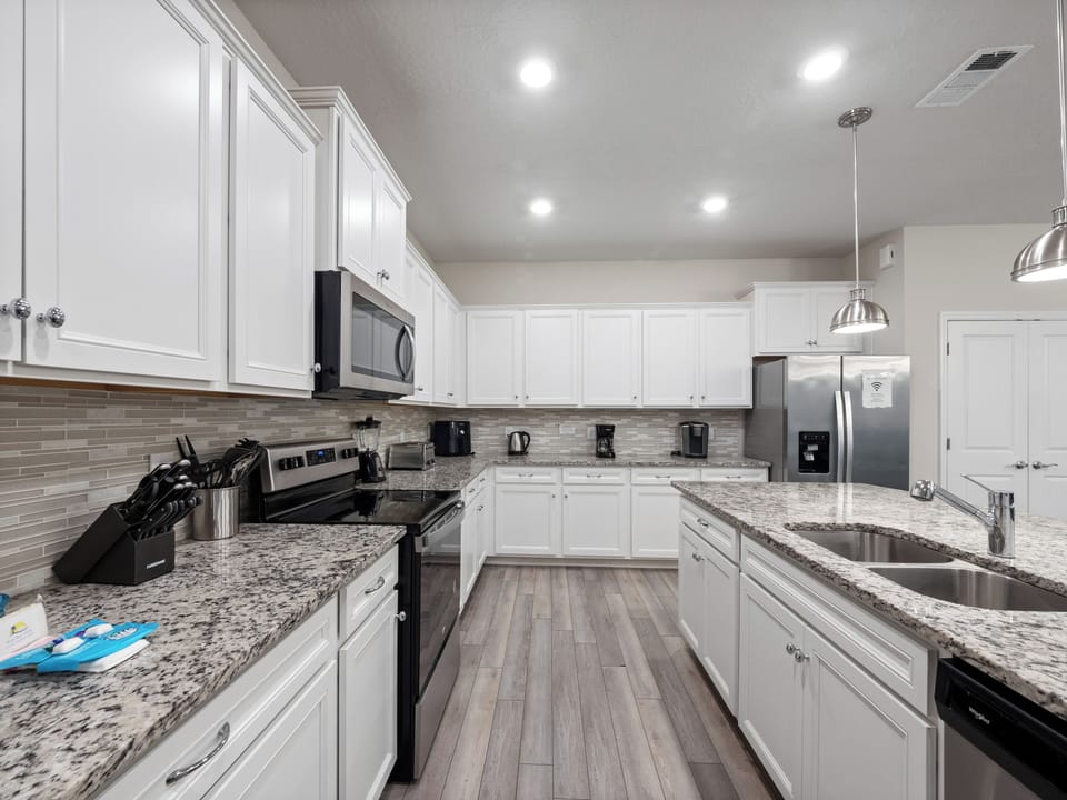 Modern Full Size Kitchen with Kitchen Essentials Including Refrigerator, Microwave, and Dishwasher