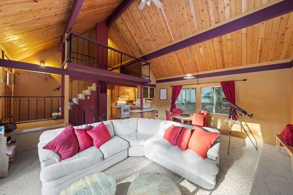 Cozy living room featuring a large smart TV, inviting fireplace, - Cozy living room featuring a large smart TV, inviting fireplace, and telescope for stargazing.