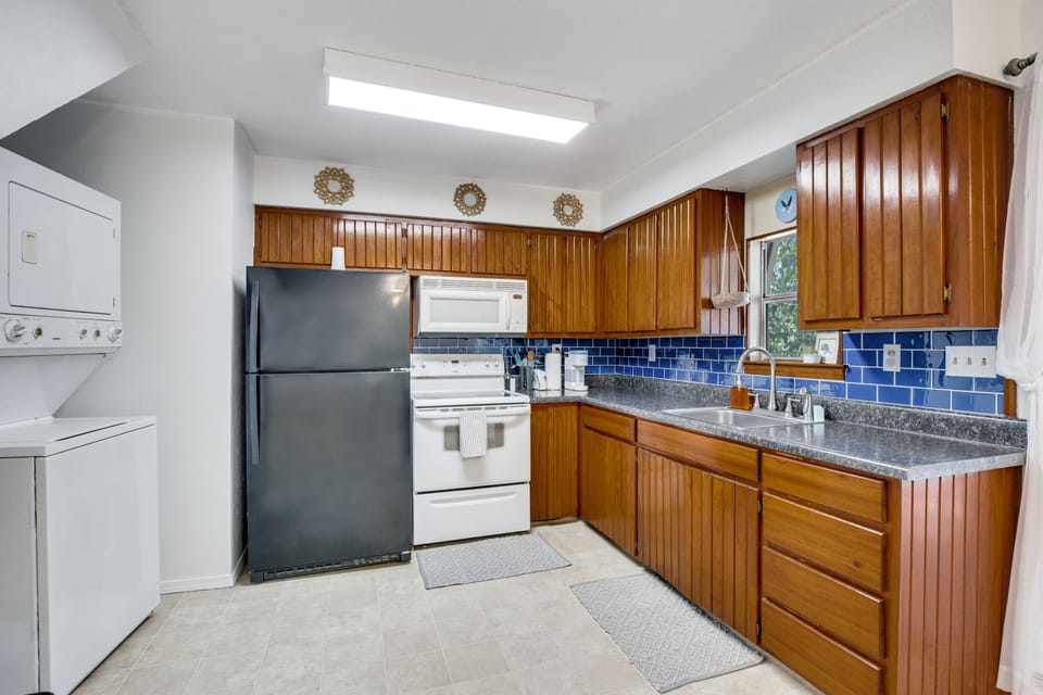 The kitchen with all the dishes and utensils you need and multiple appliances