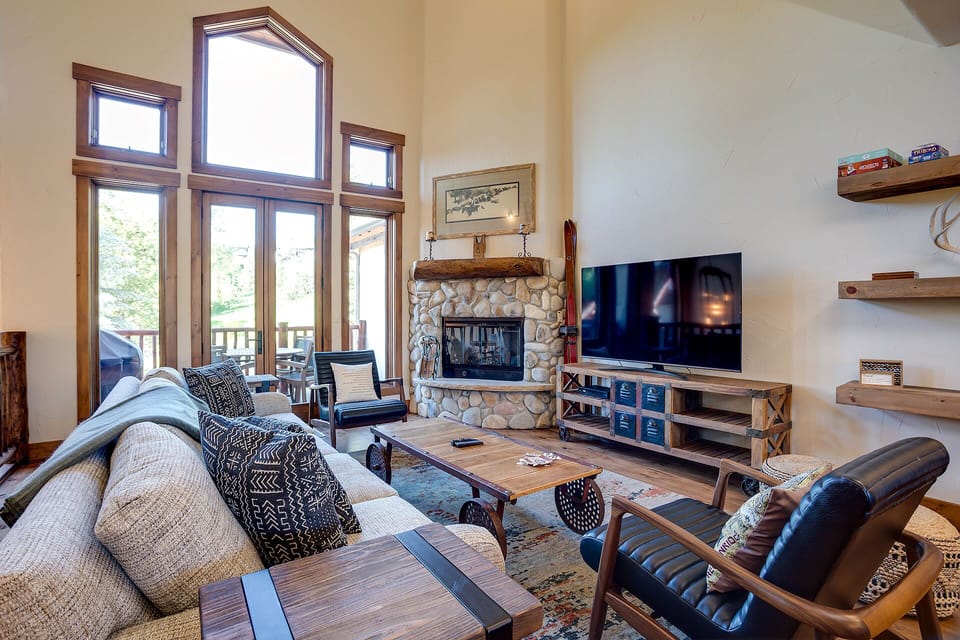 Sink into plush seating by the stone fireplace while enjoying your favorite shows on the large TV in this mountain-inspired living space.