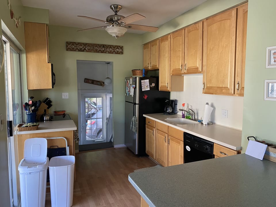 Kitchen leading out to back door, driveway and lower level.