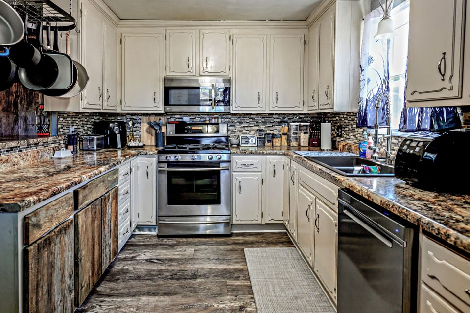 Fully stocked kitchen with stainless appliances and rustic charm.