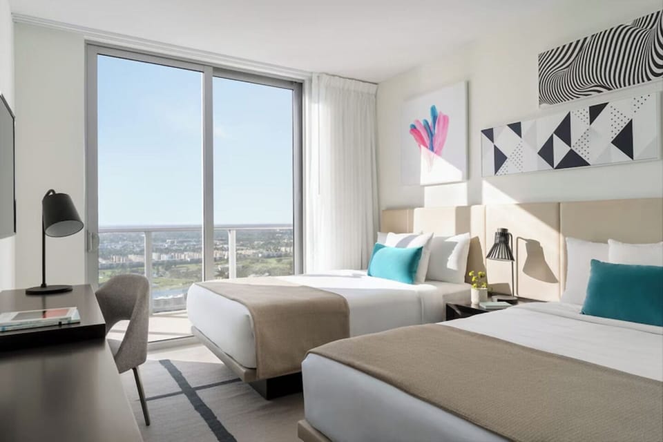 Stretch out in serene beds while sunlight pours through windows.