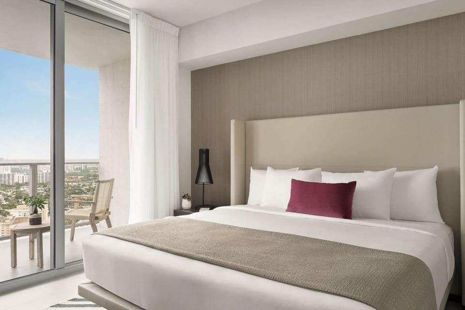 Wake up refreshed with skyline views from plush bedding.