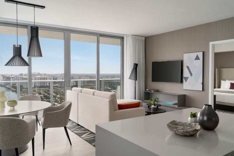 Unwind on the sofa as floor-to-ceiling windows shine.