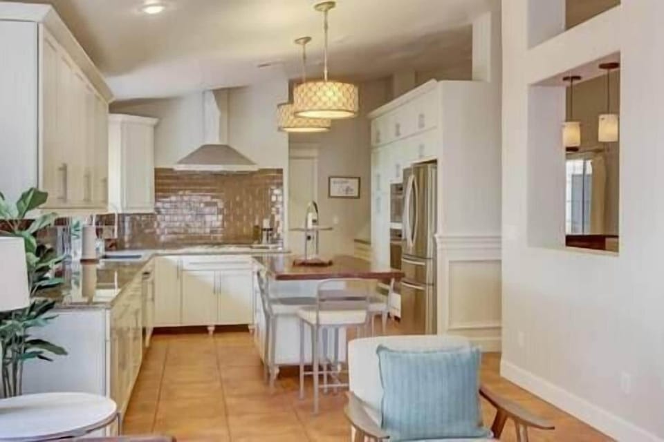 Kitchen is upgraded with white cabinets and dazzling back splash. 