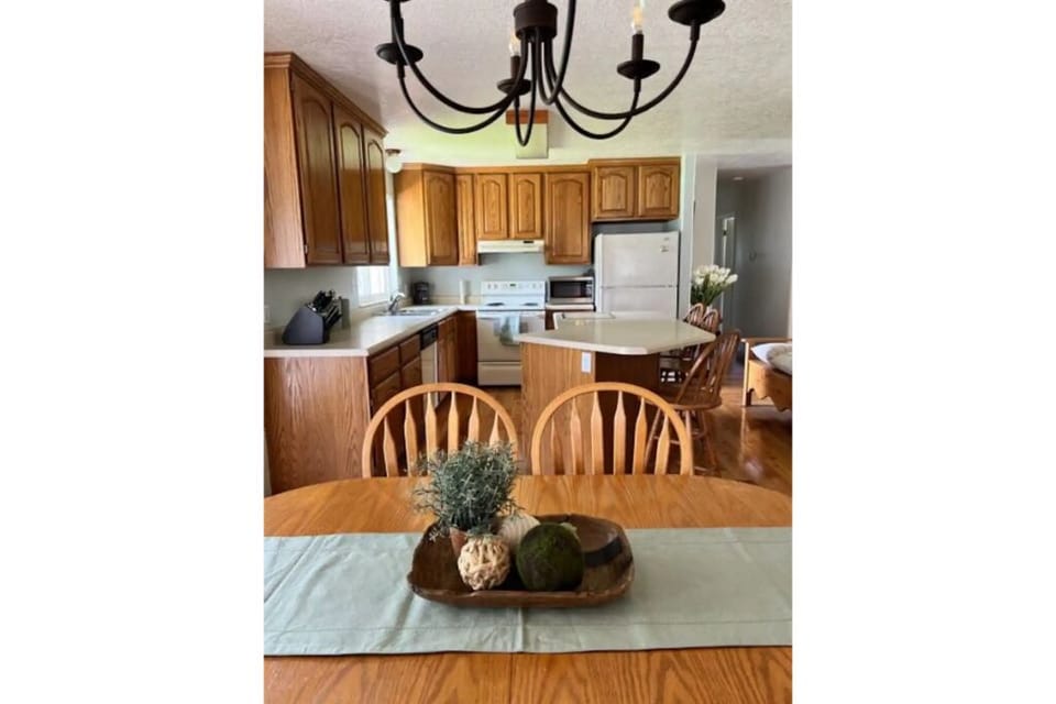 Full size kitchen fully stocked with island and 3 bar stools.