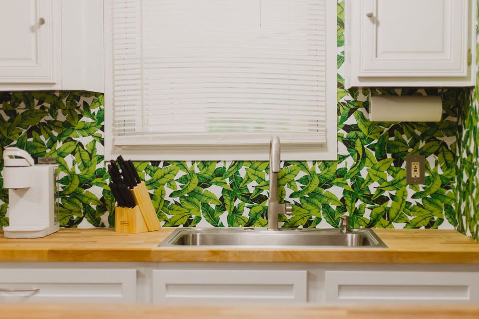 New butcher block counter top and with a large basin sink. 