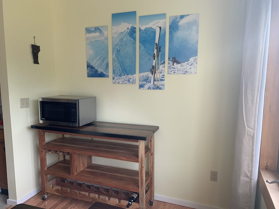 Side table with microwave, wine rack, and storage