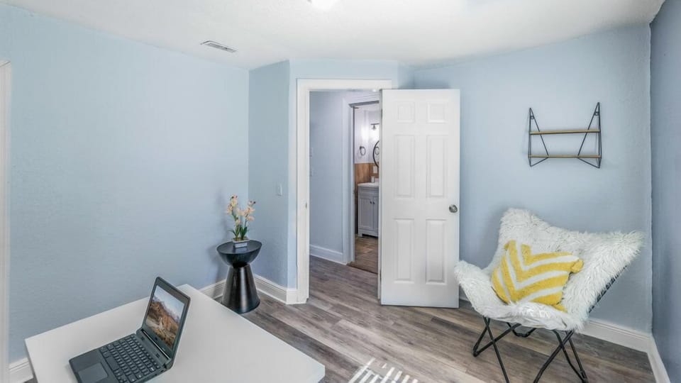 This office includes a desk and stylish chairs, creating a professional and inviting workspace.