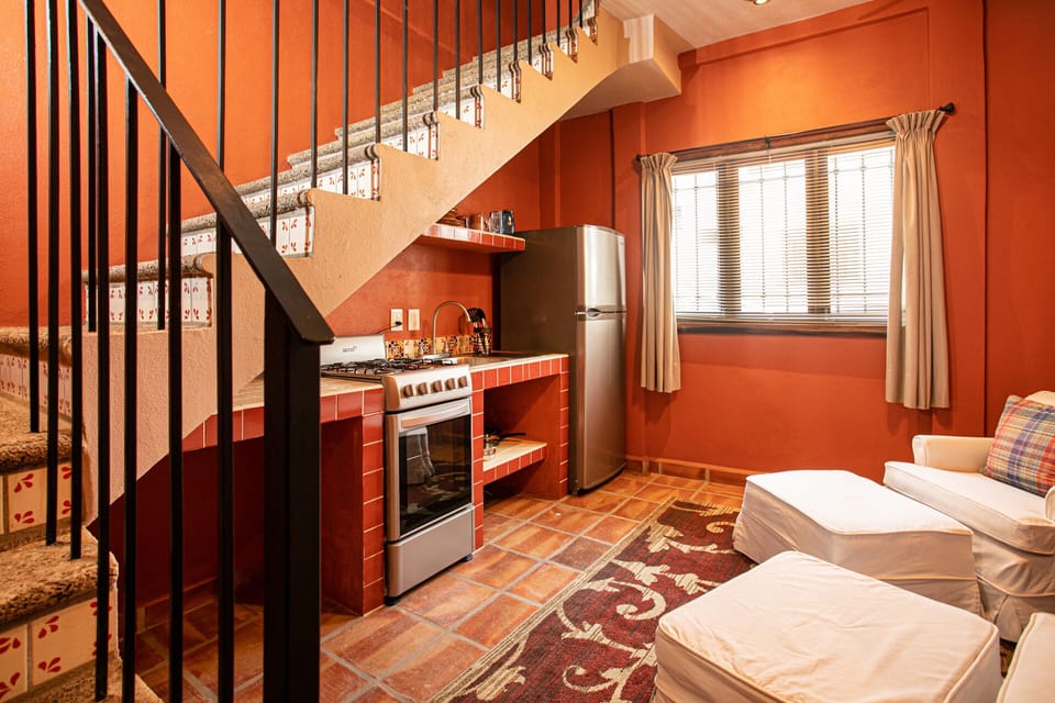 First/bottom floor Studio with sitting area and private kitchen Stair to bedroom