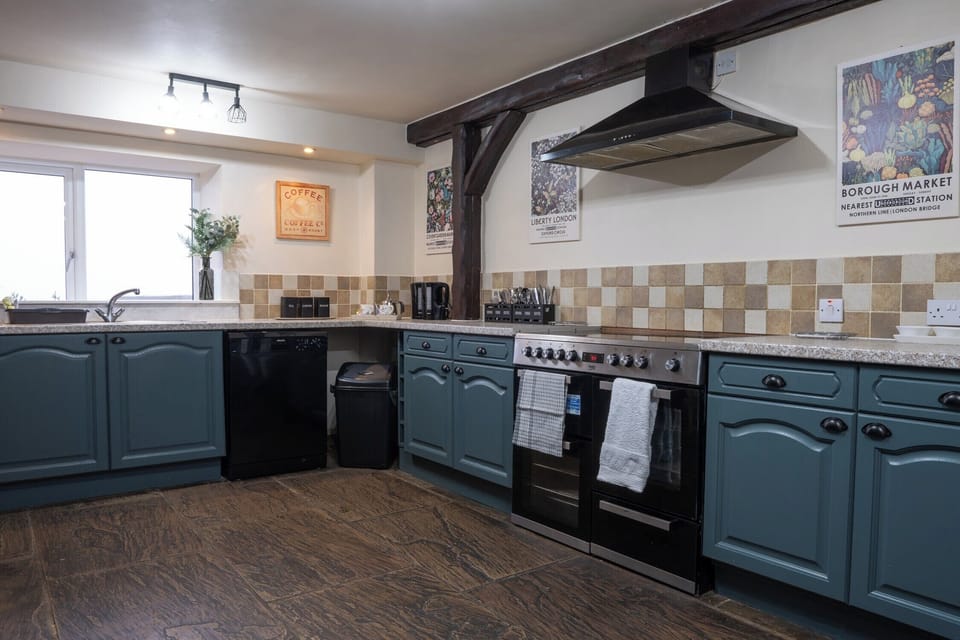 Spacious kitchen with American fridge freezer, range cooker, dishwasher and microwave.  The kitchen is equipped to cater for large groups including crockery, glasses and cooking equipment.