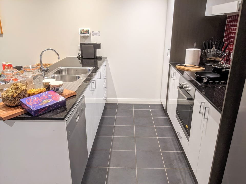 Full kitchen with oven, washing machine, electric stovetop, fridge and freezer