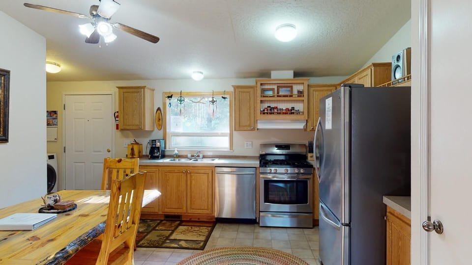 Full size kitchen equipped with everything you might need to cook a meal.