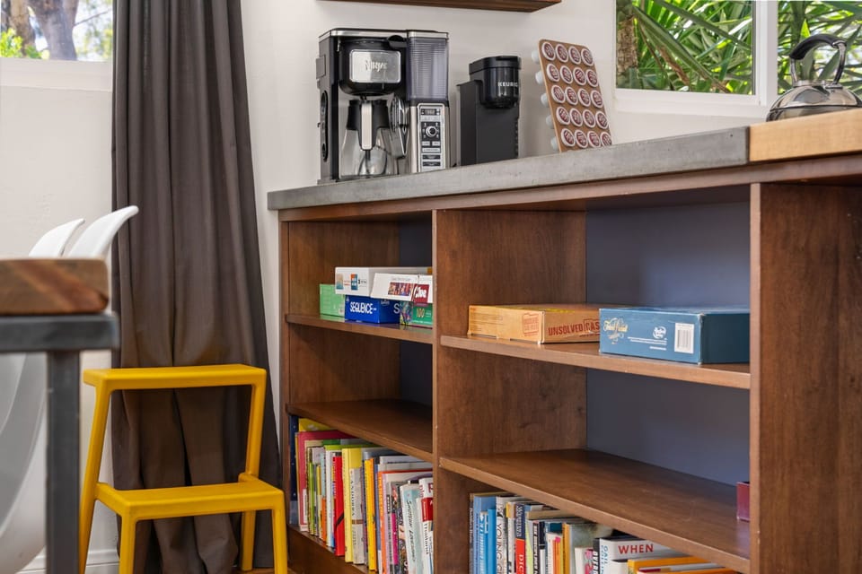 Your personal coffee station awaits, stocked with a premium espresso maker and single-serve brewer. Browse books and board games from the built-in shelves.