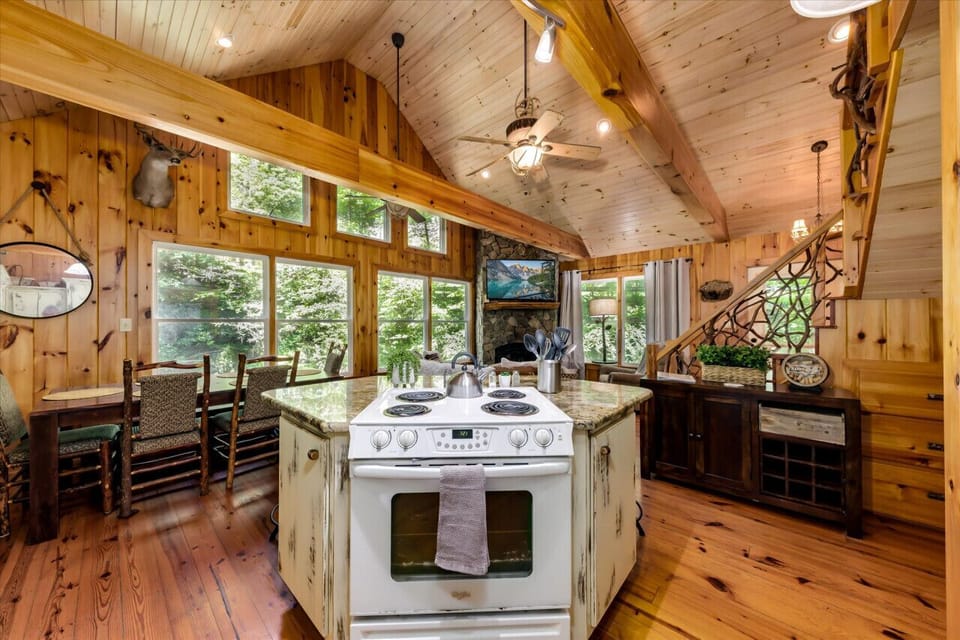 Kitchen overlooking the living room and dining area with view of Bailey creek through the windows.