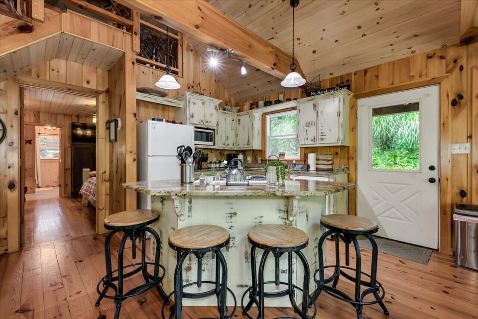 Four stools around the granite countertops.