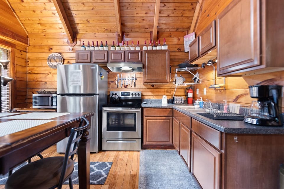Cozy log cabin kitchen with modern stainless steel appliances