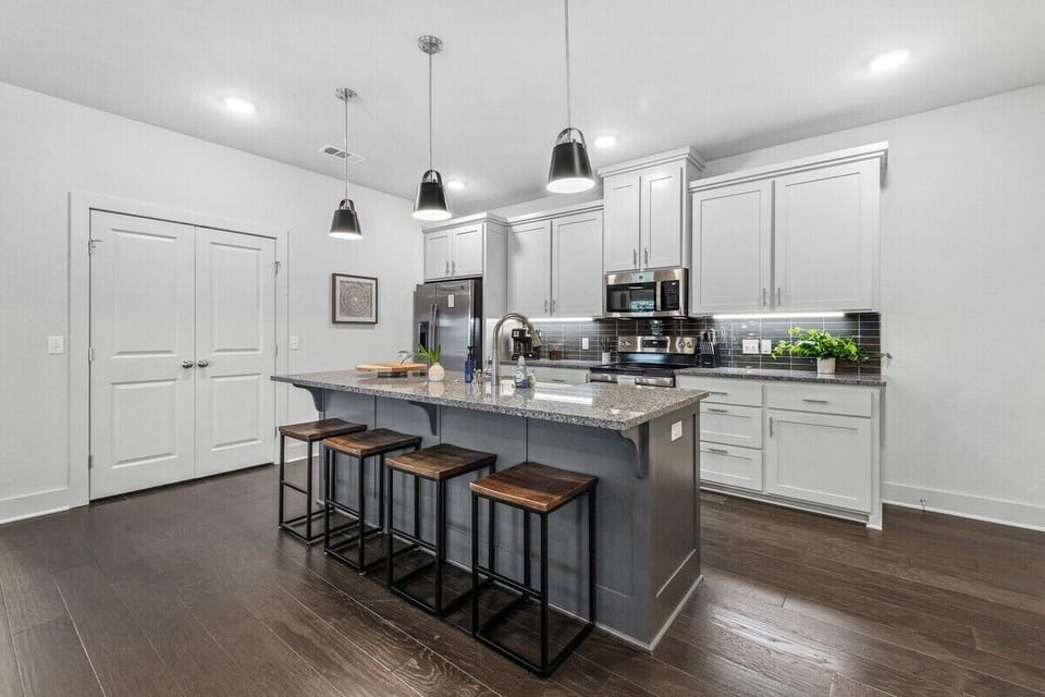 To the right, you'll see our open-concept kitchen, which is fully stocked with everything you need to cook your favorite meals.