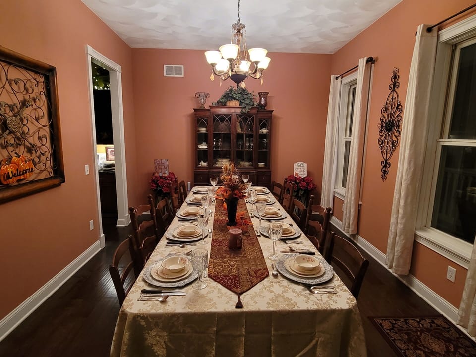 Antique dining table seats up to 14. Additional table available for more guests.