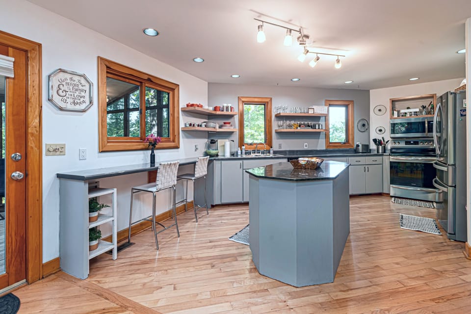 Fully stocked kitchen, island, eating area. Large fridge w/ice maker, appliances