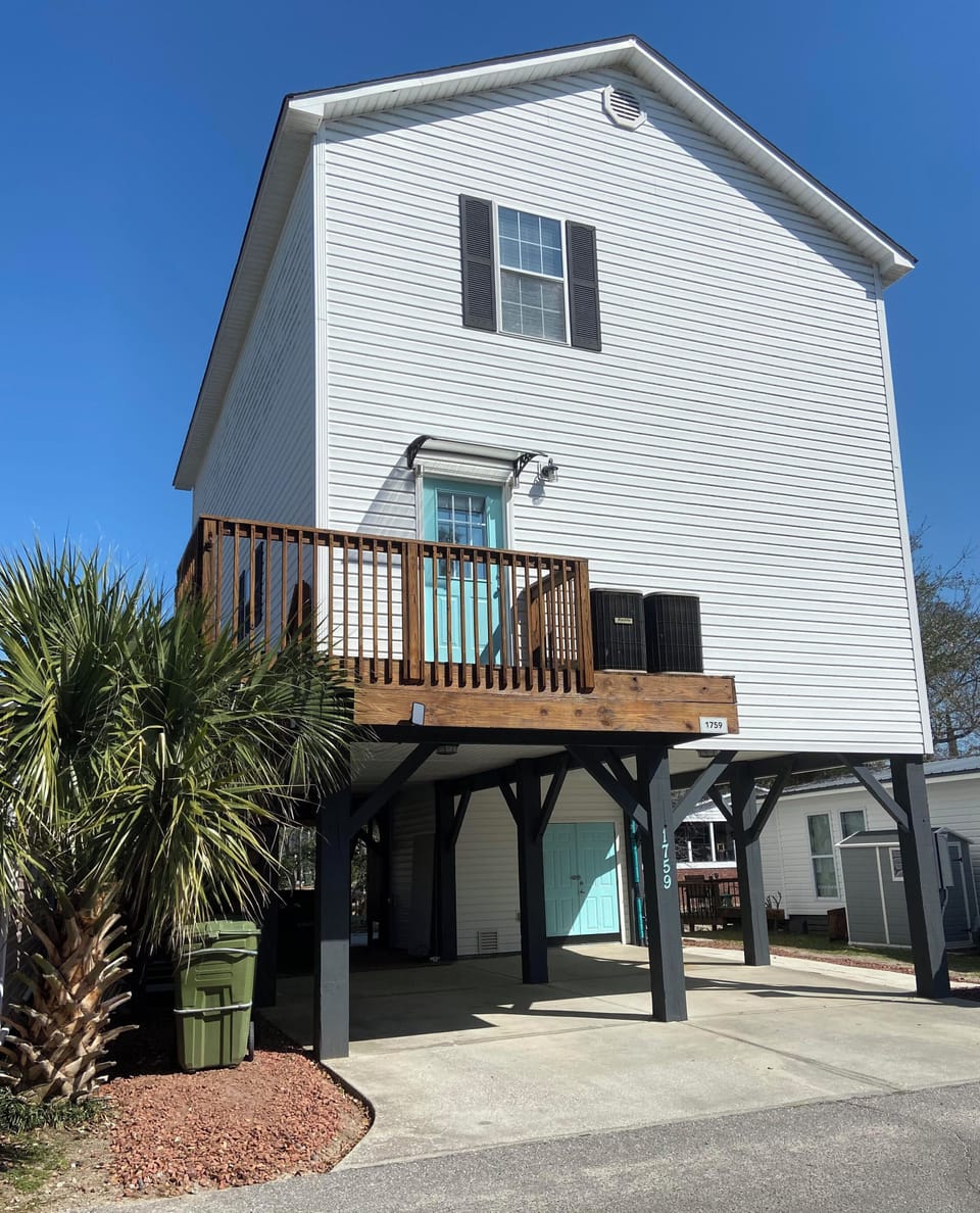 Stilt home provides comfortable parking for 2 vehicles and 2 golf carts