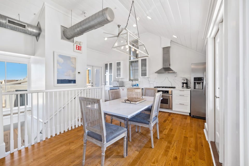 The fourth floor Main level 
features an open living kitchen dining space, east and west balconies, and a powder room.