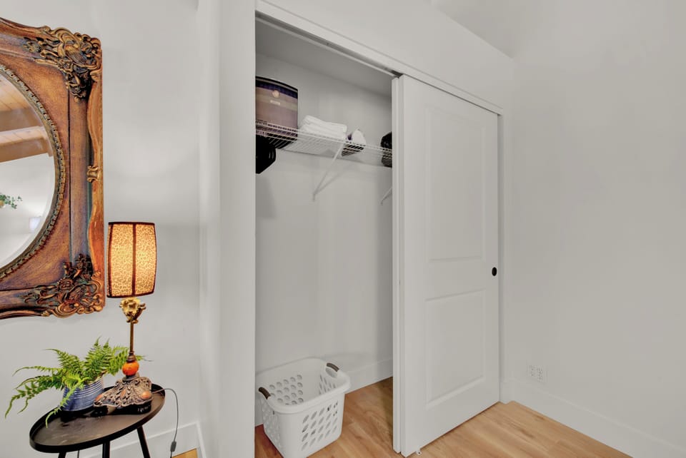 Master cloaset with iron, ironing board, extra sheets, towels and hangers