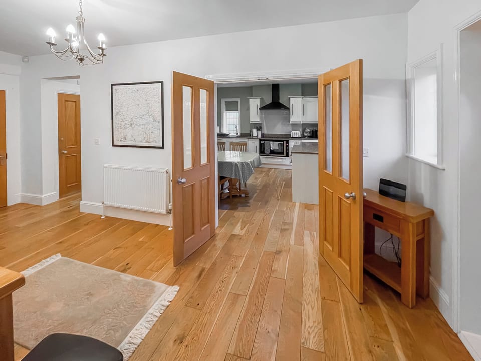 Looking through to the kitchen from the spacious hallway | Tudor House - Grange Farm Cottages, Portington