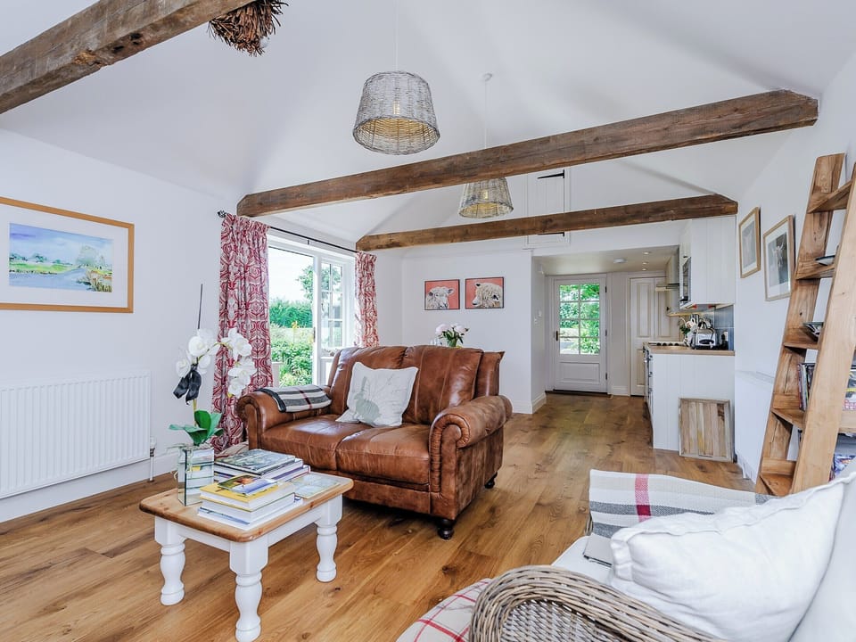 Open plan living space with wood flooring and exposed beams | The Bull Pen, Lawford