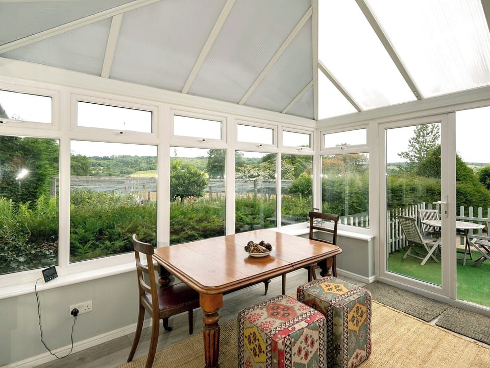 Relaxing conservatory/dining room | Tor Hatch Cottage, Guildford