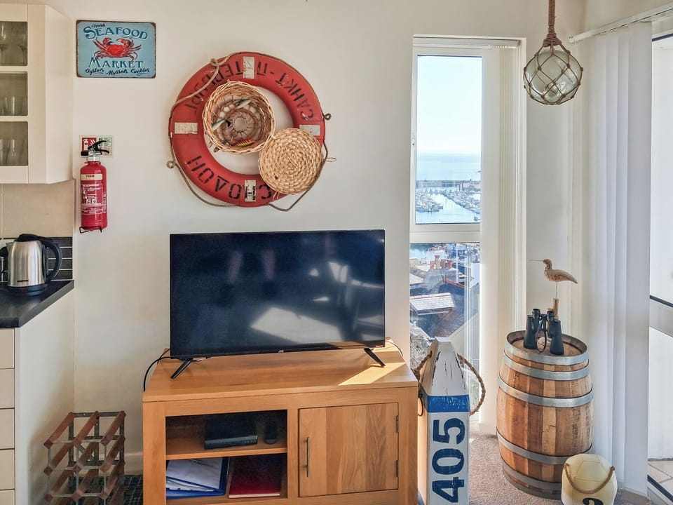 Lovely lounge area overlooking the harbour with an added side window giving extra light and dynamic views. | Upper Deck - Linden Court Apartments, Brixham