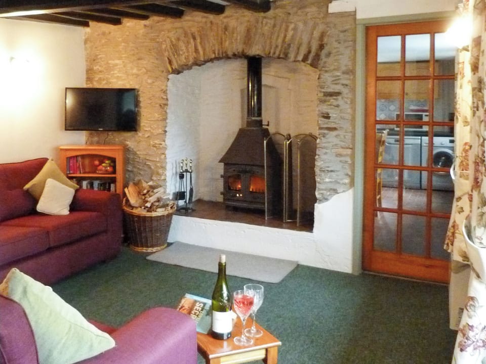 Welcoming living room with wood burner | Rose Cottage - Triscombe Farm Country Cottages, Wheddon Cross, Exmoor