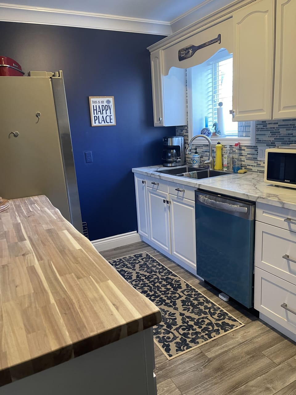 Kitchen with dishwasher, large fridge with ice and water