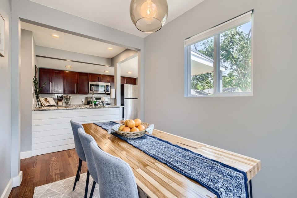 Alternate angle of dining room looking into kitchen with lots of natural light