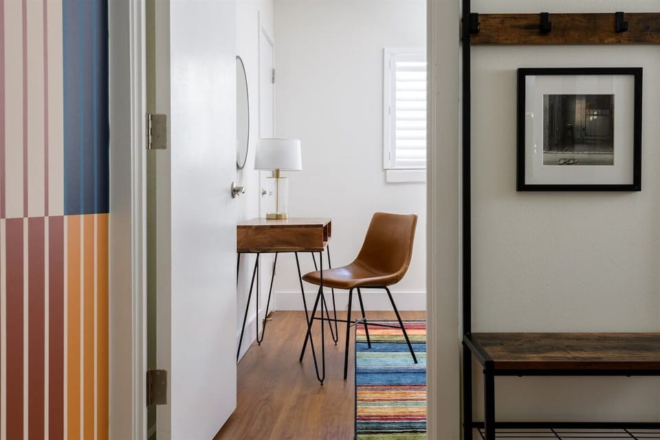 Pop of color with clean lines—this nook blends mid-century charm with playful vibes. The rainbow rug is the real MVP.