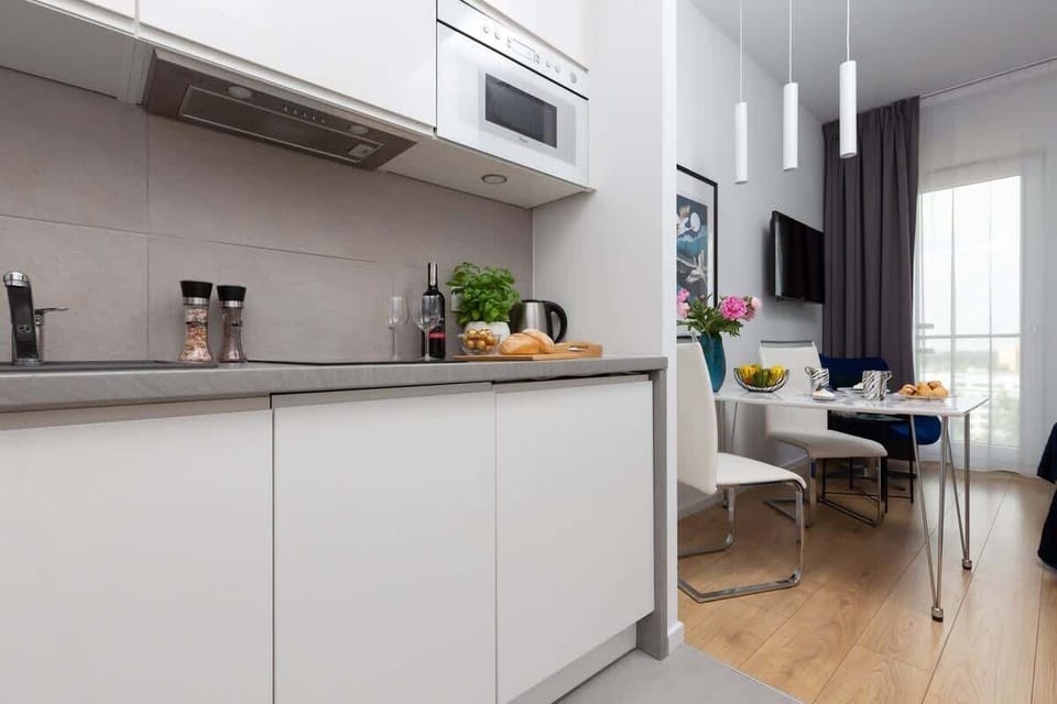 The sleek design of the kitchenette blending seamlessly with the living area.