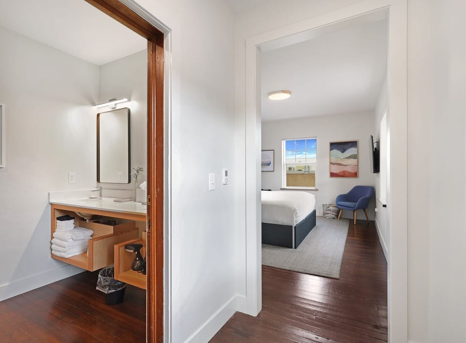Professionally restored 100 year old hardwood floors in a light filled room with all new furnishings. 