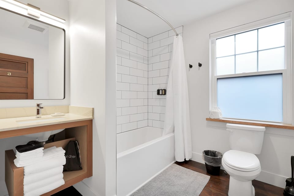 Beautiful new tile shower with modern bathtub for soaking after a day of exploring