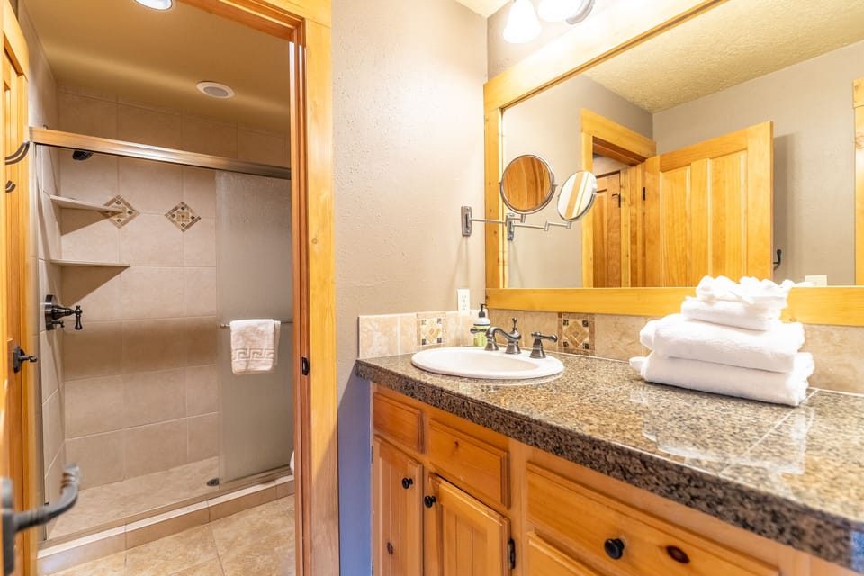 Unwind in your spacious bathroom with granite counters, fresh towels, and a relaxing walk-in shower after your mountain adventures.