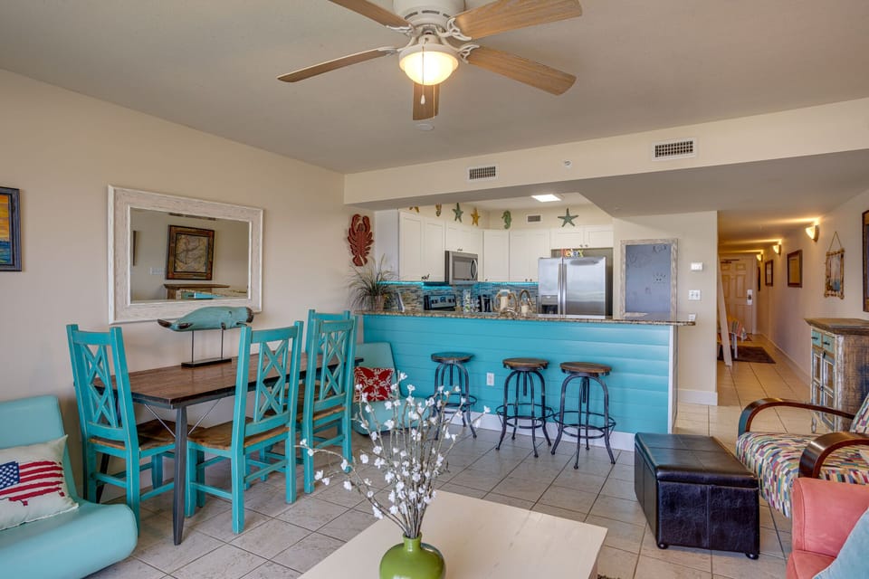 Open floor plan with full kitchen and breakfast bar. 