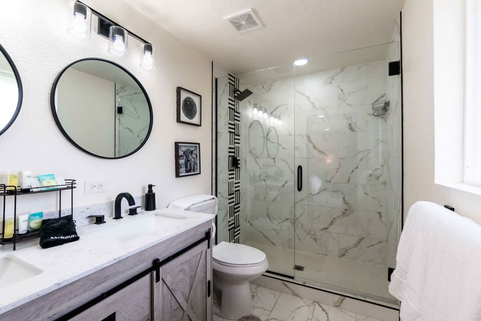 The master bathroom has double sinks and an exquisite tiled shower.