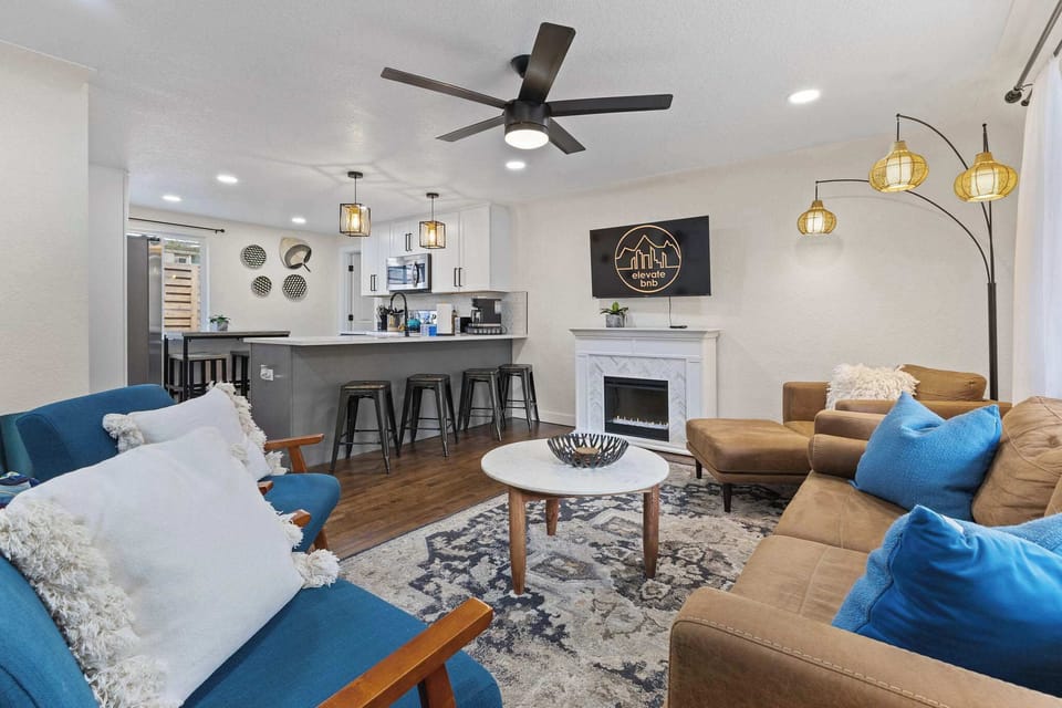 The kitchen opens to the living room and there are 3 countertop stools.