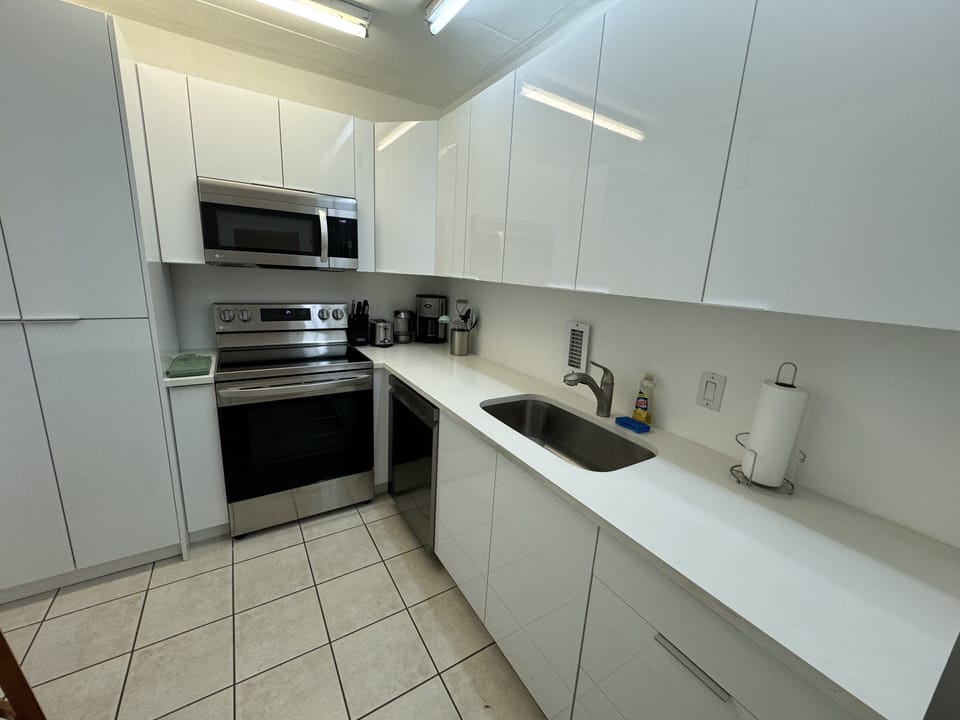 Newly remodeled kitchen with stainless steel microwave and stove and dishwasher
