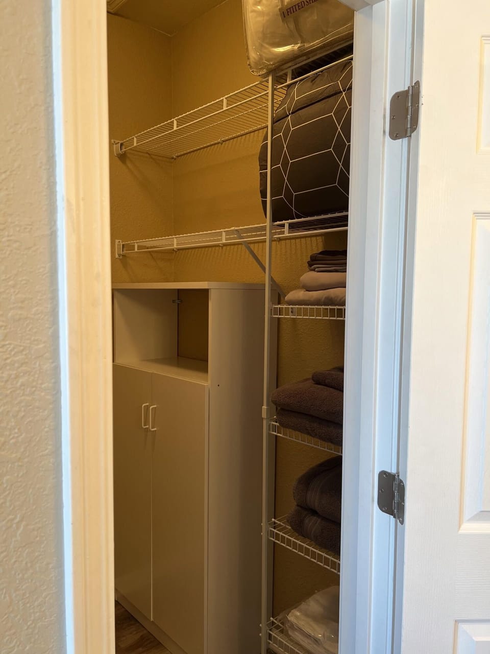 Another view of the primary suite walk-in closet. 